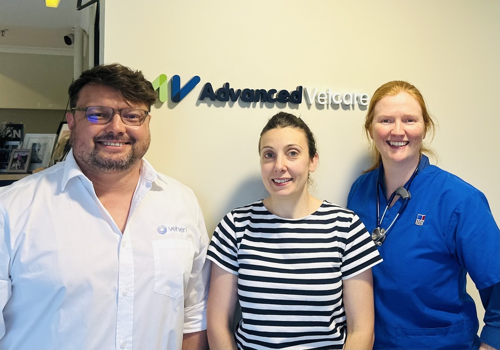 Three members of the Advanced Vetcare and Veheri teams standing together.